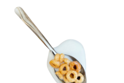 Spilled Honey Nut Cheerios With Milk On Spoon realistic fake food prop by FakeFood4U
